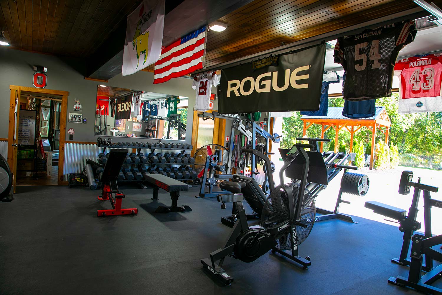 State-of-the-art workout gym with jerseys hanging overhead.