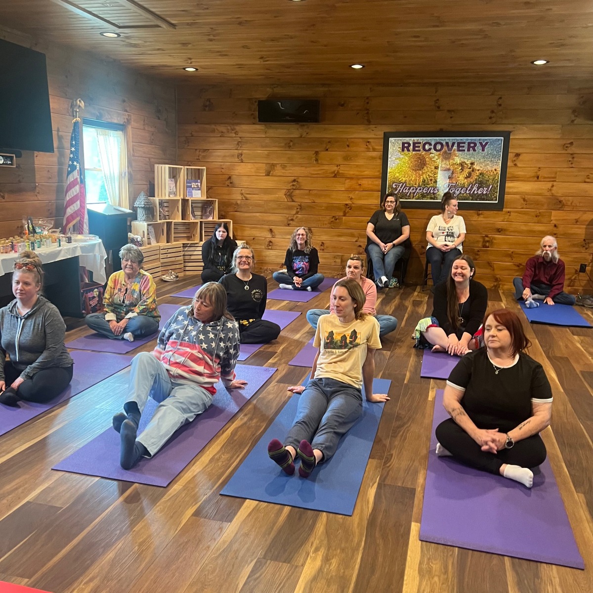 Yoga class with everyone sitting on their own yoga mats
