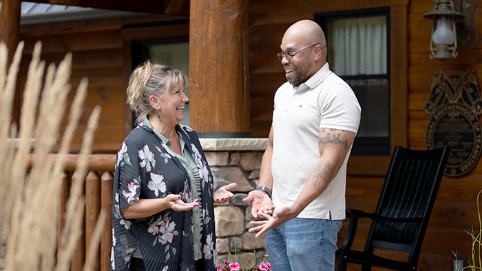 A woman and man speaking and laughing together.