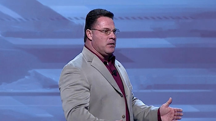 Travis speaking at an engagement.